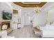 Large main bedroom with fireplace, hardwood floors, and water views at 17601 Sawgrass Run, Tavares, FL 32778