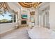Elegant bedroom with water views, fireplace, and hardwood floors at 17601 Sawgrass Run, Tavares, FL 32778