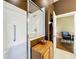 Walk-in shower with built-in seat and linen storage at 25611 Maurepas Ln, Leesburg, FL 34748
