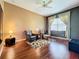 Bright bedroom with hardwood floors and sitting area at 25611 Maurepas Ln, Leesburg, FL 34748