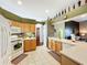 Modern kitchen with light wood cabinets and tiled backsplash at 25611 Maurepas Ln, Leesburg, FL 34748