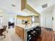 Kitchen island with seating and a view into the living room at 25611 Maurepas Ln, Leesburg, FL 34748