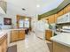 Kitchen boasts ample cabinetry, tiled floors and modern appliances at 25611 Maurepas Ln, Leesburg, FL 34748