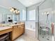 Large bathroom with double vanity, tub, and walk-in shower at 25611 Maurepas Ln, Leesburg, FL 34748
