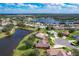 Aerial view showcasing a house's location near a lake at 25611 Maurepas Ln, Leesburg, FL 34748