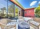 Patio with wicker chairs and a view of the pond at 25611 Maurepas Ln, Leesburg, FL 34748