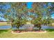Tranquil backyard with a bench overlooking a pond at 25611 Maurepas Ln, Leesburg, FL 34748