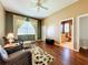 Spacious bedroom with hardwood floors and sitting area at 25611 Maurepas Ln, Leesburg, FL 34748