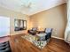 Relaxing bedroom with hardwood floors and sitting area at 25611 Maurepas Ln, Leesburg, FL 34748