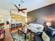 Open concept living room and kitchen with hardwood floors and a breakfast bar at 25611 Maurepas Ln, Leesburg, FL 34748
