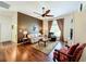 Spacious living room with hardwood floors and a ceiling fan at 25611 Maurepas Ln, Leesburg, FL 34748