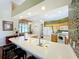 Modern kitchen with breakfast bar and white countertops at 25611 Maurepas Ln, Leesburg, FL 34748