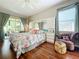 Main bedroom with hardwood floors, ceiling fan, and access to backyard patio at 25611 Maurepas Ln, Leesburg, FL 34748