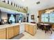 Open kitchen with island, breakfast nook, and views to Gathering room at 25611 Maurepas Ln, Leesburg, FL 34748