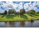 Aerial view of property showcasing home and pond views at 25611 Maurepas Ln, Leesburg, FL 34748