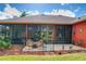Inviting patio with seating area and screened enclosure at 25611 Maurepas Ln, Leesburg, FL 34748