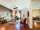 Bright living room features hardwood floors, a ceiling fan, and comfortable seating at 25611 Maurepas Ln, Leesburg, FL 34748