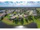 Aerial view of a residential community situated beside a lake at 25611 Maurepas Ln, Leesburg, FL 34748