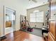 Home gym with equipment and a view of the bathroom at 25611 Maurepas Ln, Leesburg, FL 34748