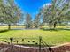 Serene backyard oasis with pond views and a charming bench at 25611 Maurepas Ln, Leesburg, FL 34748