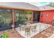 Relaxing patio featuring a fire pit and wicker furniture at 25611 Maurepas Ln, Leesburg, FL 34748