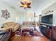 Spacious living area with hardwood floors, comfortable furniture, and a TV at 25611 Maurepas Ln, Leesburg, FL 34748