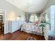 Main bedroom features hardwood floors and a ceiling fan with backyard access at 25611 Maurepas Ln, Leesburg, FL 34748