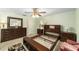 Bright bedroom featuring a large dresser and ceiling fan at 3 Fir Trl, Ocala, FL 34472