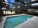 Refreshing screened pool with a tiled deck and steps at 3 Fir Trl, Ocala, FL 34472