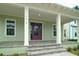 Charming front porch with purple door and brick steps at 9934 Fiddley Aly, Orlando, FL 32827