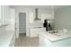Modern kitchen with white cabinets, quartz countertops, and walk-in pantry at 9934 Fiddley Aly, Orlando, FL 32827