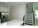 Modern staircase with black railing leading to the second floor at 9934 Fiddley Aly, Orlando, FL 32827