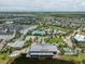 Aerial view of community with resort-style pool, clubhouse, and lake at 9934 Fiddley Aly, Orlando, FL 32827