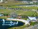 Aerial view of a community featuring a lake with inflatable water park, sports fields, playground, and fitness area at 10552 Pearson Ave, Orlando, FL 32827