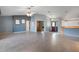 Large living room with tile floors and views to other rooms and the front door at 24814 Riverboat Bnd, Leesburg, FL 34748