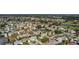 Aerial perspective of a residential area featuring houses, roads, and a golf course at 1312 Landeros Ln, The Villages, FL 32159