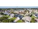 Aerial view of a residential area with houses, landscaping, and a water tower at 1312 Landeros Ln, The Villages, FL 32159