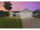 A charming single-story home with a two-car garage and manicured lawn at 1312 Landeros Ln, The Villages, FL 32159