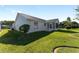 House exterior with a screened patio and well-manicured lawn at 1312 Landeros Ln, The Villages, FL 32159