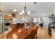Bright dining area with hardwood floors, a wood table, and access to the kitchen at 1312 Landeros Ln, The Villages, FL 32159