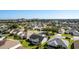 Aerial view of a community with houses, green spaces, and a resort in the background at 1312 Landeros Ln, The Villages, FL 32159