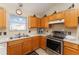 Modern kitchen with wood cabinets, stainless steel appliances, and a kitchen island at 1312 Landeros Ln, The Villages, FL 32159