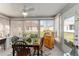 Bright sunroom with table and chairs, offering backyard views at 1312 Landeros Ln, The Villages, FL 32159