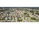 Aerial view of a community with numerous houses, lush landscaping, and a golf course at 1312 Landeros Ln, The Villages, FL 32159