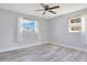 Spacious bedroom with wood-look vinyl flooring and two large windows at 2030 Leisure Dr, Winter Haven, FL 33881
