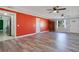 Bright living room featuring wood-look vinyl flooring and an accent wall at 2030 Leisure Dr, Winter Haven, FL 33881