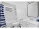 Clean bathroom with white tile, a bathtub, and a modern vanity at 2030 Leisure Dr, Winter Haven, FL 33881