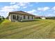 Large backyard with grassy area and home exterior view at 17257 Se 113Th Ave, Summerfield, FL 34491