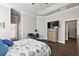 Main bedroom with large TV, dresser and en-suite bathroom at 17257 Se 113Th Ave, Summerfield, FL 34491