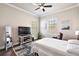 Comfortable bedroom with a large TV and plenty of natural light at 17257 Se 113Th Ave, Summerfield, FL 34491